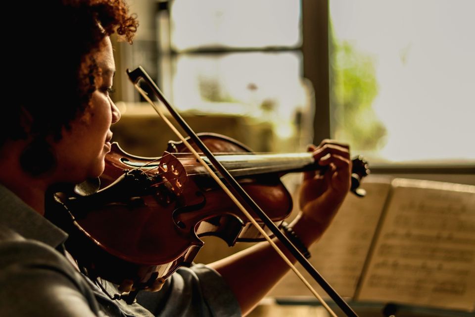 Violoniste jouant avec son archet devant une partition